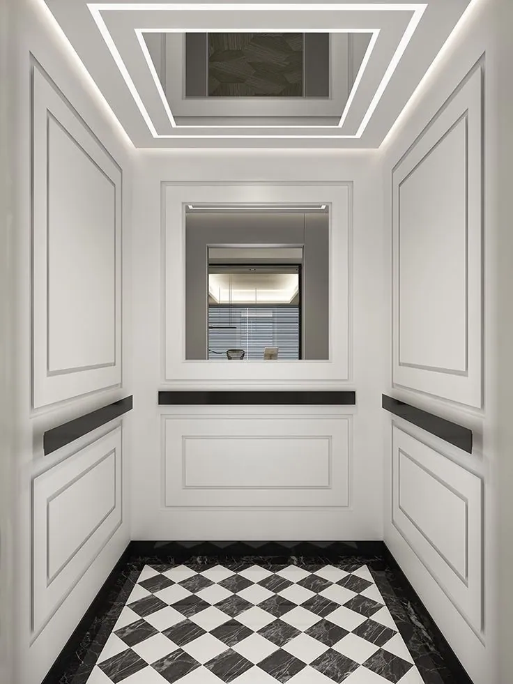 Classic white lacquer panelled elevator cabin with black marble handrail, checkered marble floor and recessed LED cove ceiling — Liftech Global Pakistan