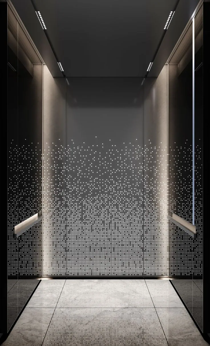 Dark titanium black stainless elevator cabin with perforated starlight LED wall, brushed bronze handrails and marble floor