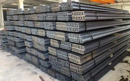 Bundled stack of hollow formed elevator guide rails in a steel warehouse awaiting cutting and delivery for lift installation projects in Pakistan