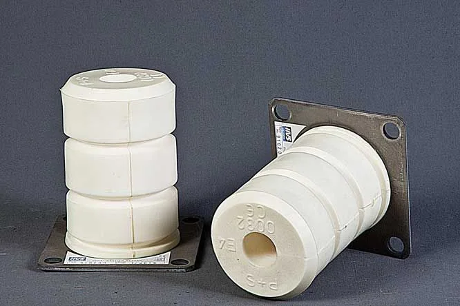 Pair of white cellular polyurethane elevator buffers with CE and EN 81 markings mounted on stainless steel base plates